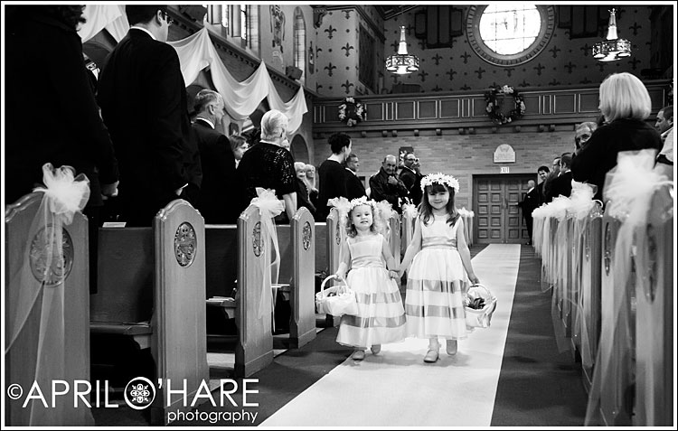 A B&W Photo of Colorado flower girls walking down the aisle at St. Catherines in Denver