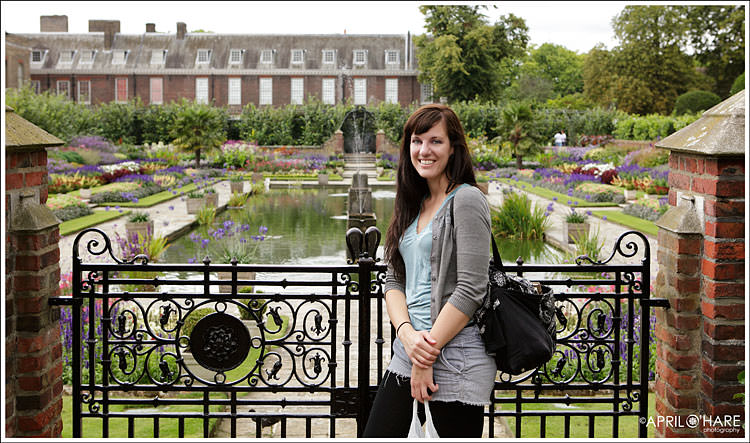 Tourist standing in garden at Kensington Palace in London
