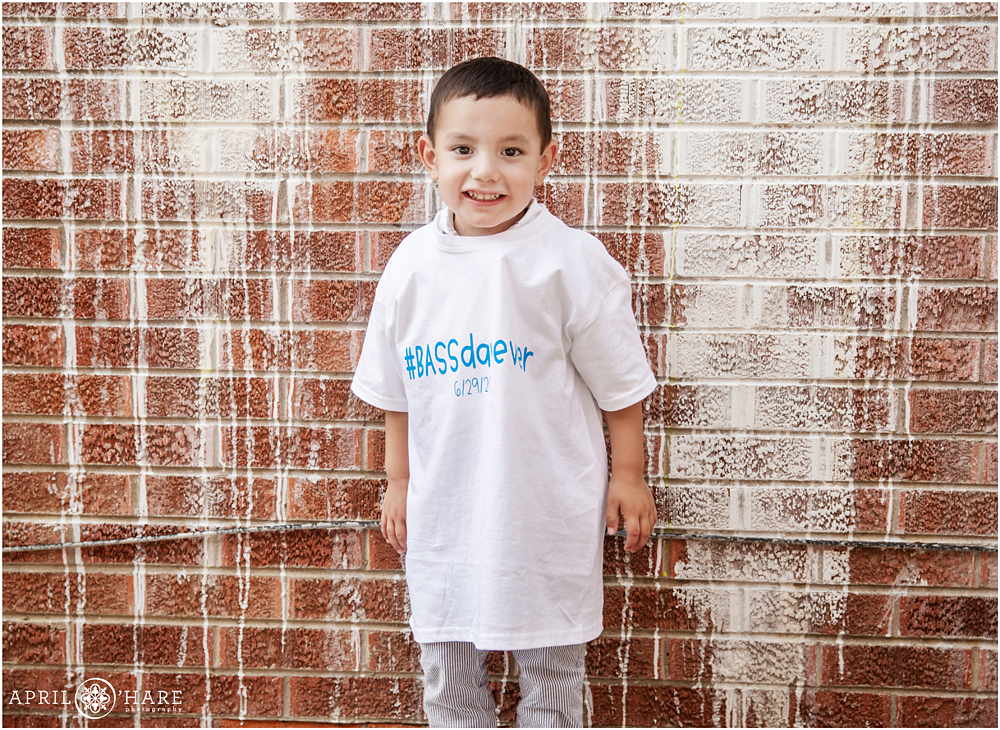 Sweet young boy on his adoption day with a fun family tshirt in Greeley Colorado