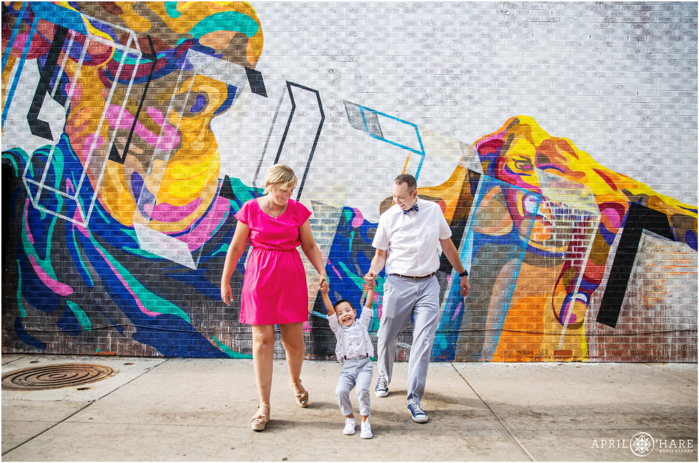 Happy family portrait in a colorful alleyway in Downtown Greeley after an adoption at Weld County Court