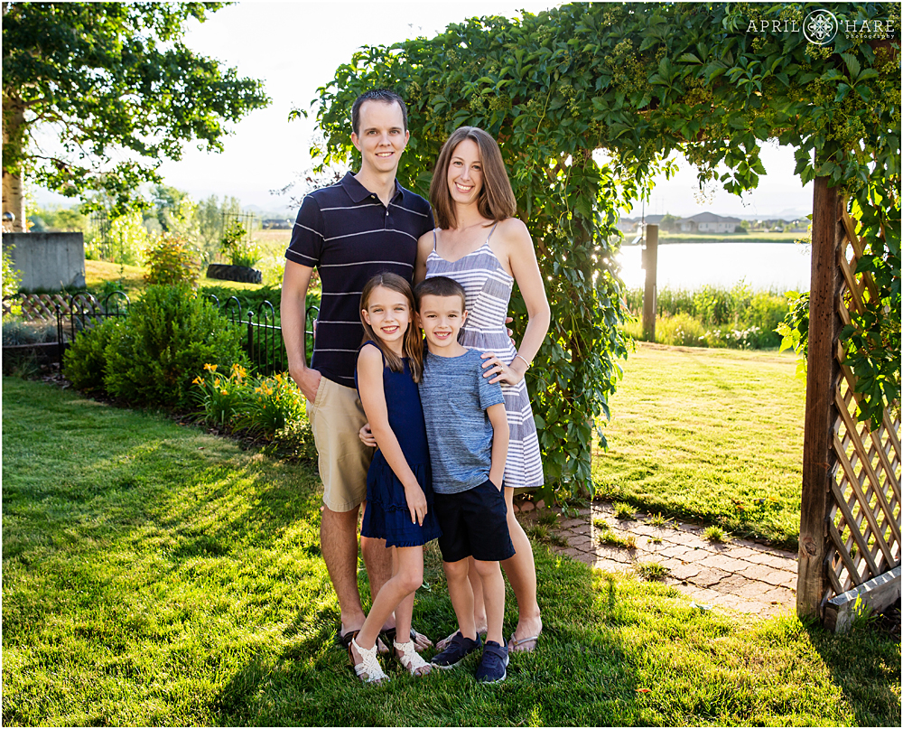 Loveland Colorado Family Photo with Vine Covered Arbor Trellis in Backyard Photoshoot