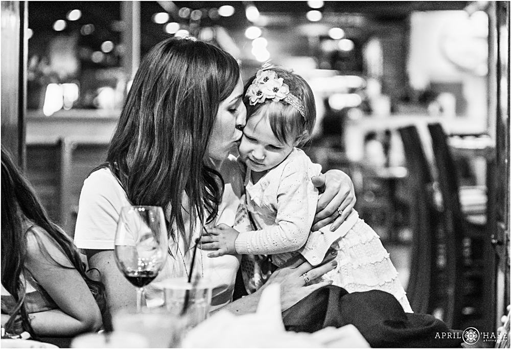 Mom kisses her daughter at a birthday party event in Louisville Colorado