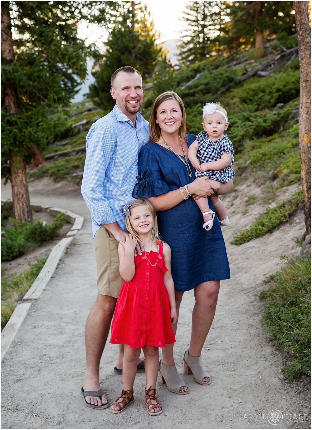 A mom and dad with their two young daughters at their outdoor Colorado family photography session at Sapphire Point
