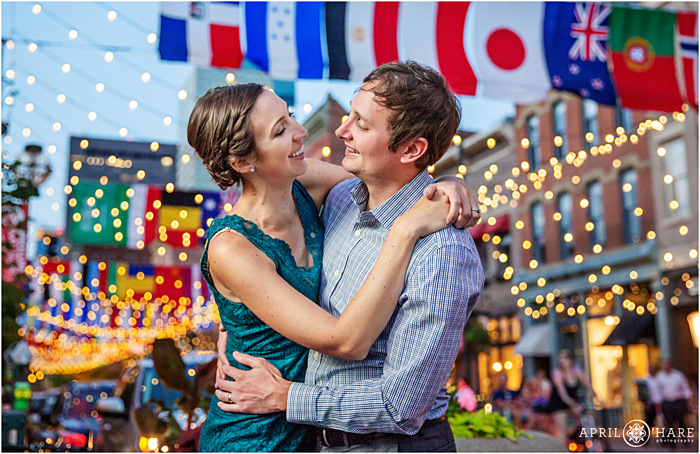 Sweet portrait of a couple in front of the string lights at Larimer Square