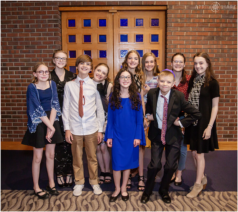 A girl poses for a candid photo with her friends at her Temple Emanuel Bat Mitzvah Luncheon in Denver CO