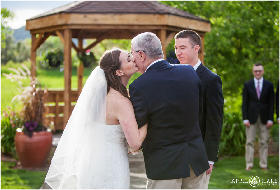Bride Kisses Her Dad During her Denver Garden Wedding at Denver Botanic Gardens Chatfield Farm in Colorado
