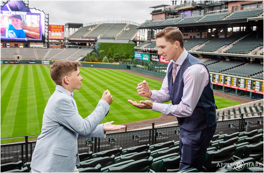 Cute brothers play a game at their baseball themed bar mitzvah at Coors Field in Denver