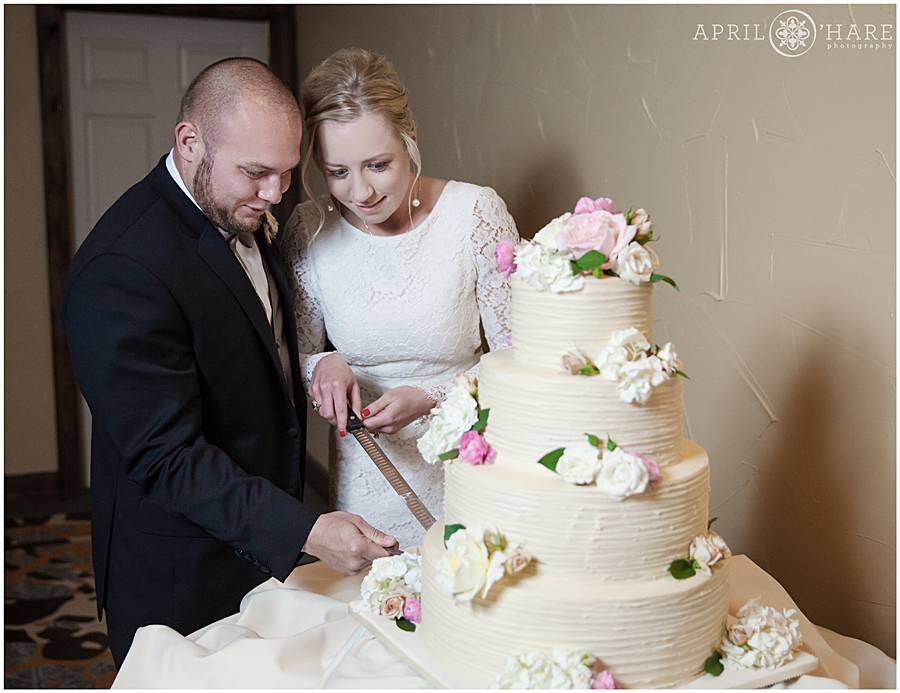 Cutting a pretty cake at Winter Wedding in Breckenridge