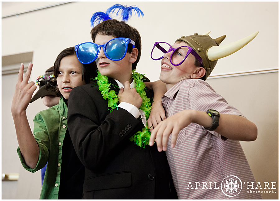 Kids playing with photobooth props at Temple Micah Bar Mitzvah in Denver CO