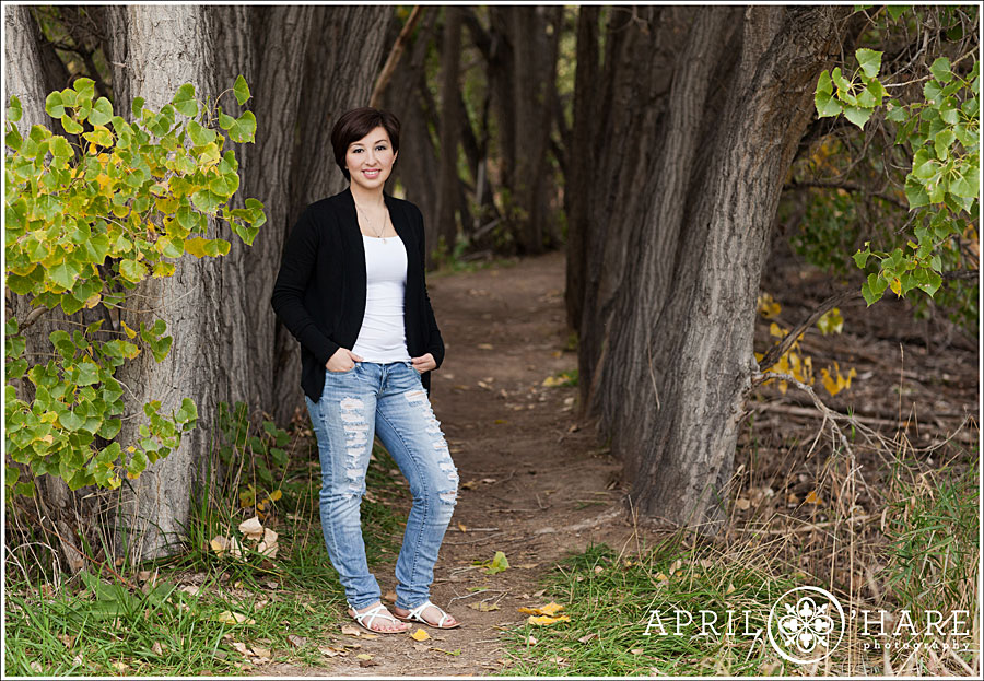 Brighton senior photos with a cool tunnel of Cottonwood trees in Colorado