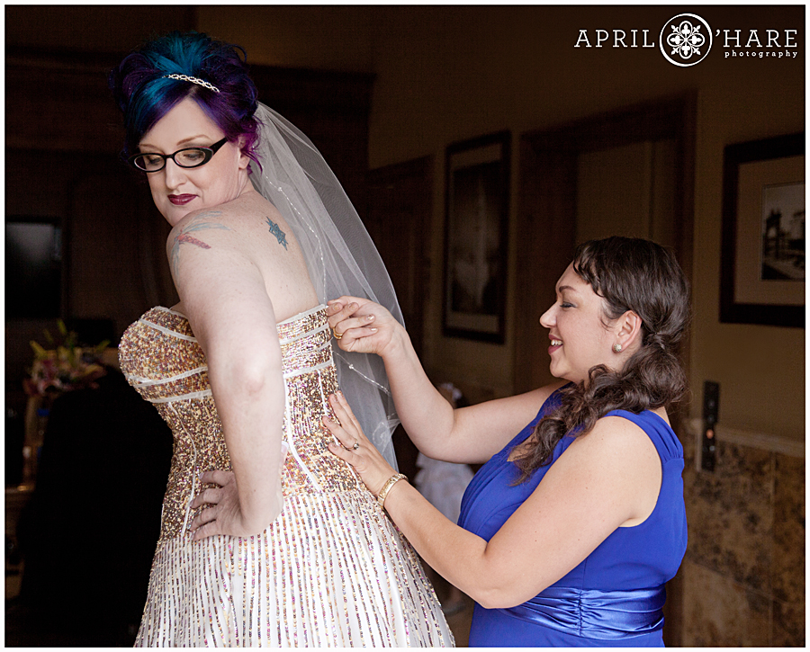 Bride with bright blue and purple hair wearing a rainbow sequin glitter wedding dress in Denver