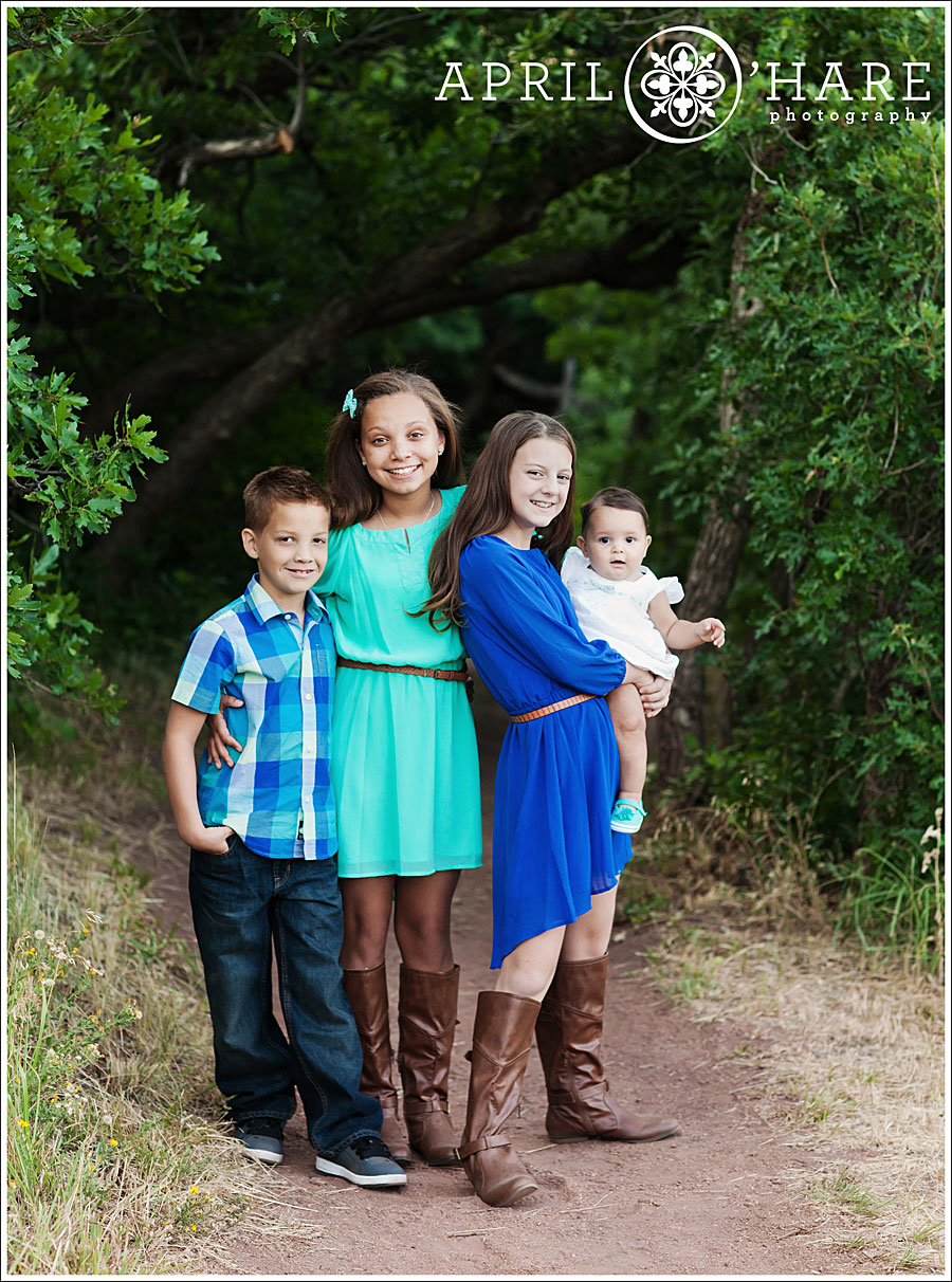 Adorable Roxborough State Park Family Photos with 4 kids wearing teal and blue