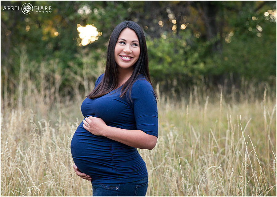 Cute pregnant mom to be poses for her maternity session in Denver CO