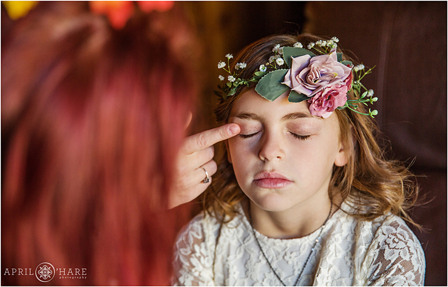 Flower girl getting ready with her flower crown at a Colorado Boho Wedding