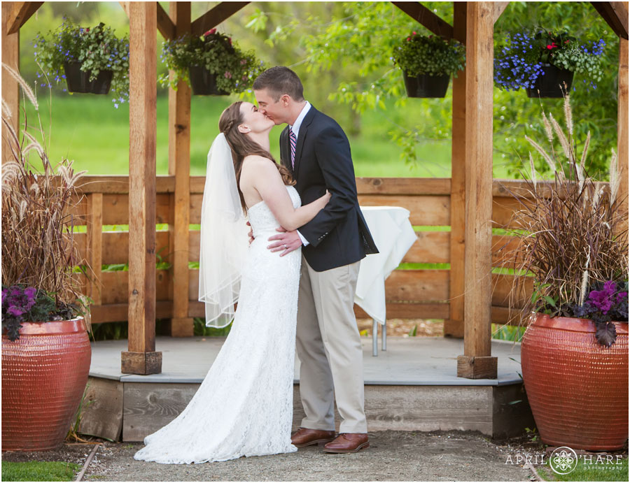 Couple kisses at their wedding ceremony at their Denver Garden Wedding Chatfield Farms 