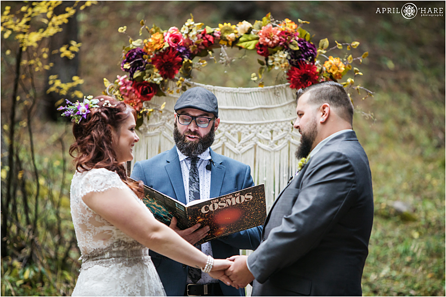 Gorgeous Colorado Boho Wedding with macrame ceremony backdrop with fall floral arch