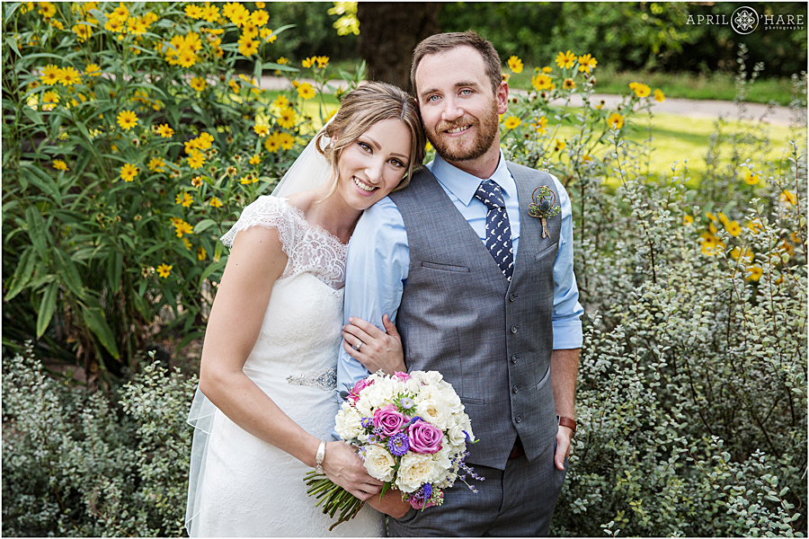 Bride and groom pose in the gardens on their Deer Creek Stables Wedding day at Chatfield Farms