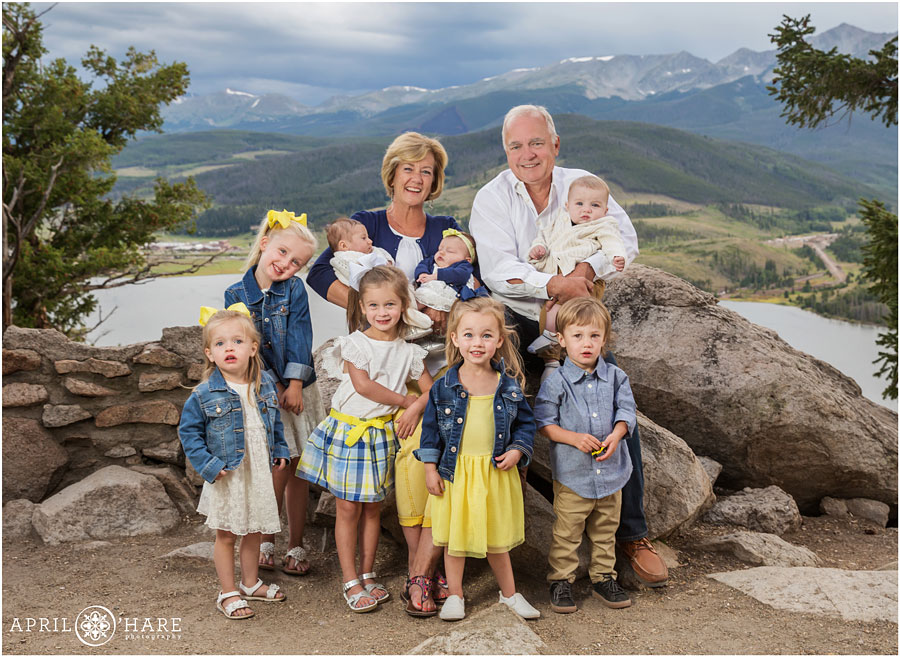 Grandparents with all of their young grandkids wearing yellow and blue clothing