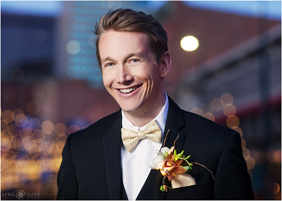 Groom portrait with a light up gold boutonniere in Denver CO