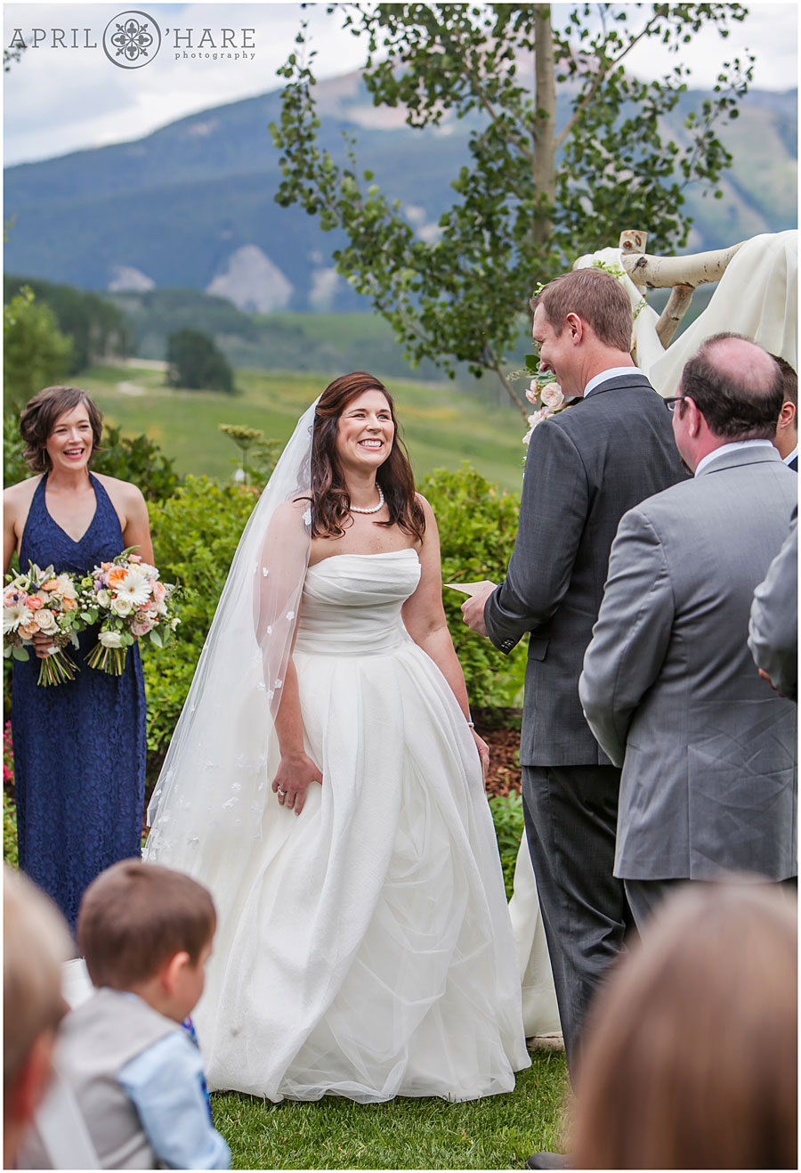 Happy bride photographed at her outdoor wedding ceremony by a Crested Butte wedding photographer
