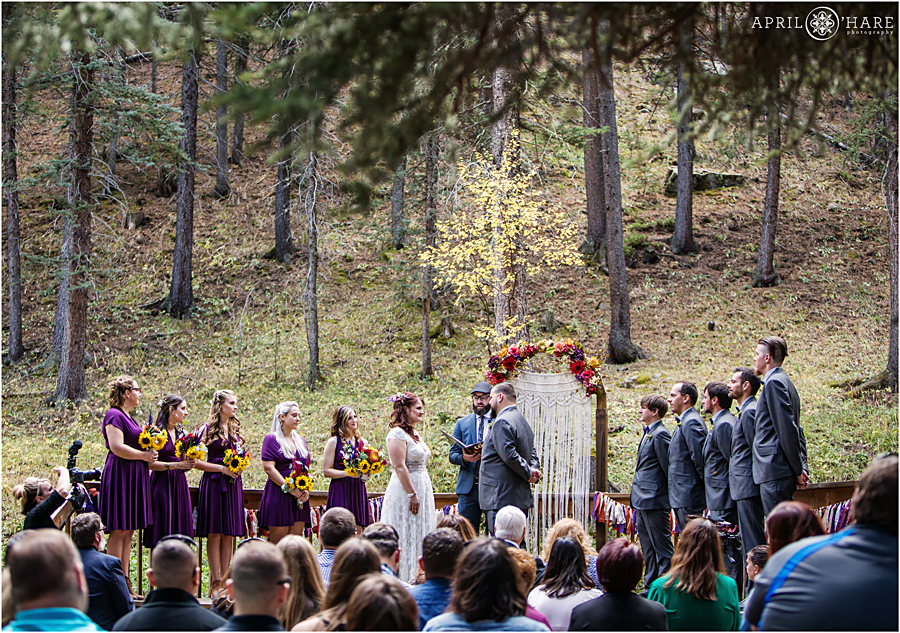 Colorado Boho Wedding in the forest with pretty macrame arch backdrop