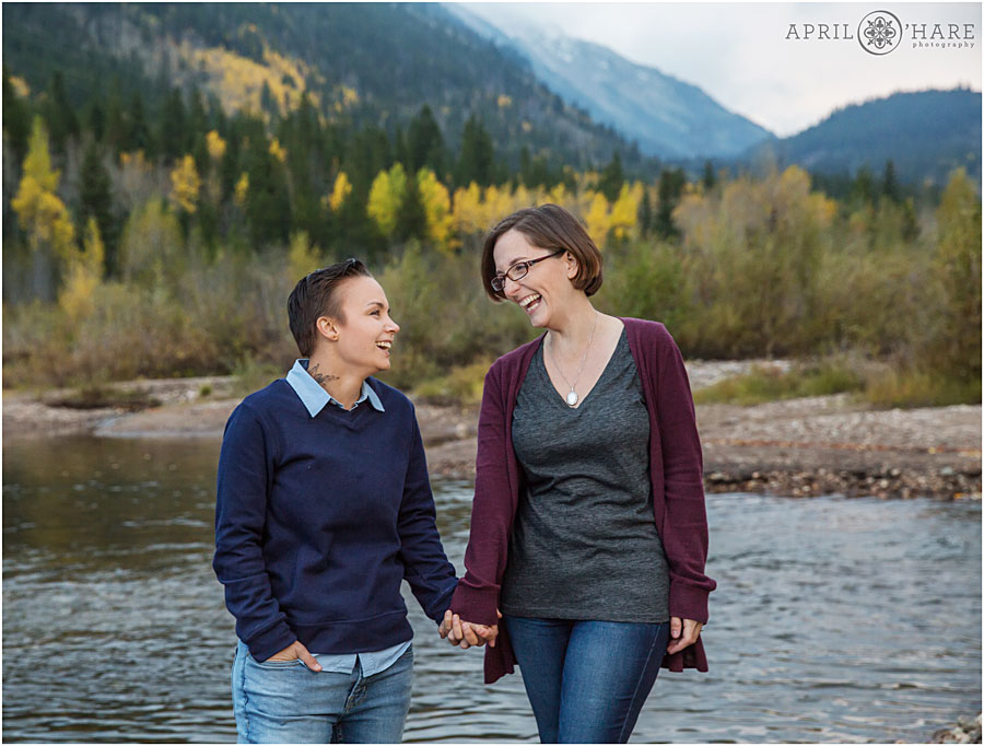 Beautiful Colorado Same-Sex Engagement Photography with mountain backdrop next to river