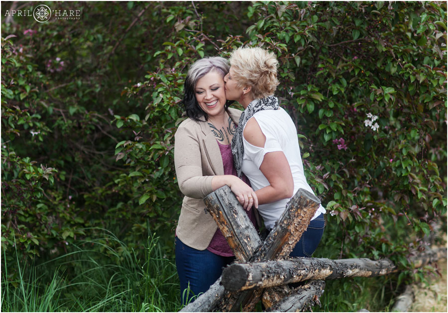 Two girls kiss at their pretty spring time Colorado Lesbian Engagement Photo session in Golden