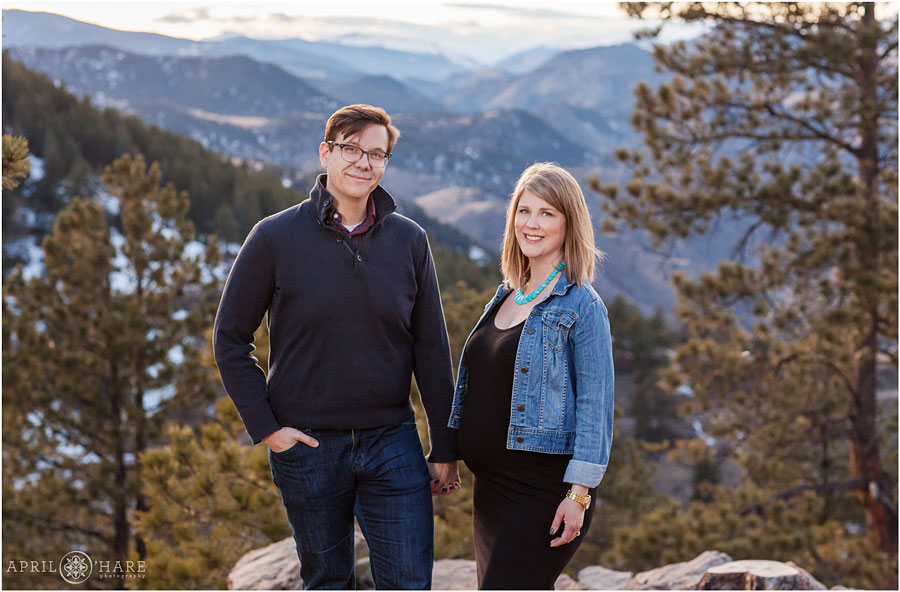 Cute couple hold hands in front of a pretty mountain view at Lookout Mountain Maternity Photos
