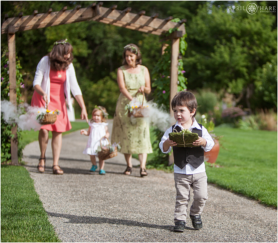 Rustic Colorado Wedding Flower Girls and Ring Bearer walk down with mist coming out of baskets at Chatfield Farms