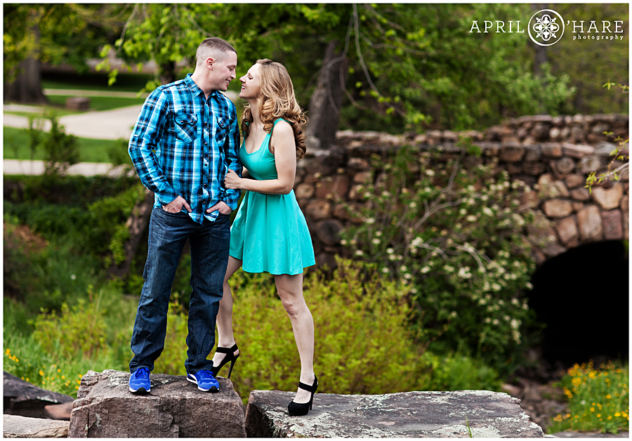 Cute CU Boulder Engagement Photos During Spring with old Stone arched bridge on Campus