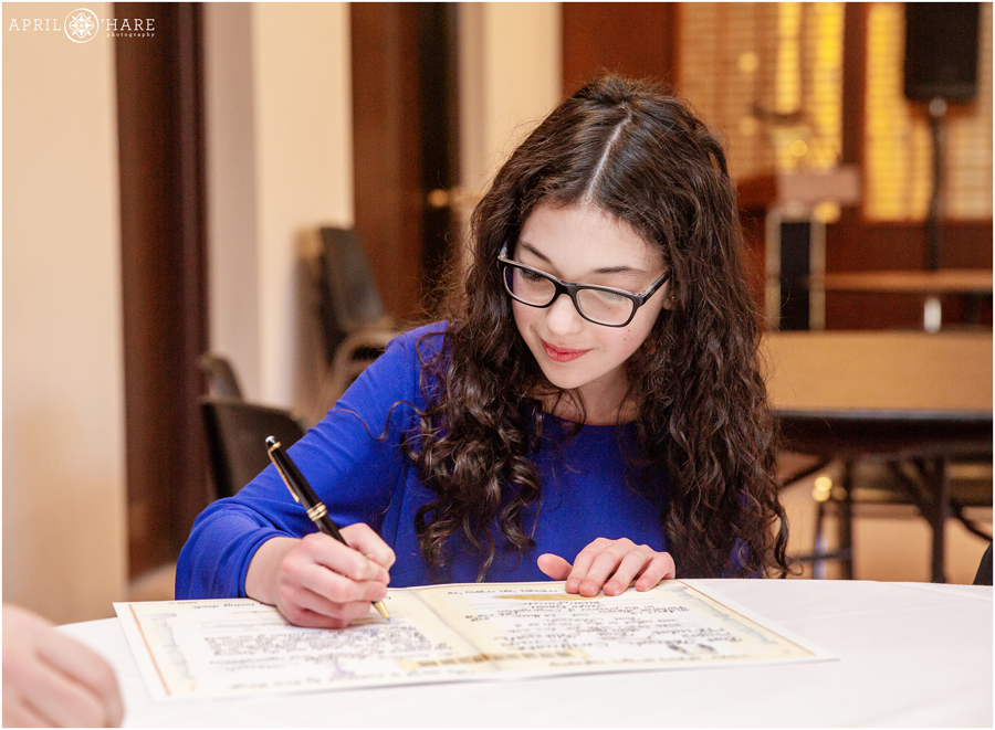 Signing the contract at her Temple Emanuel Bat Mitzvah in Denver Colorado