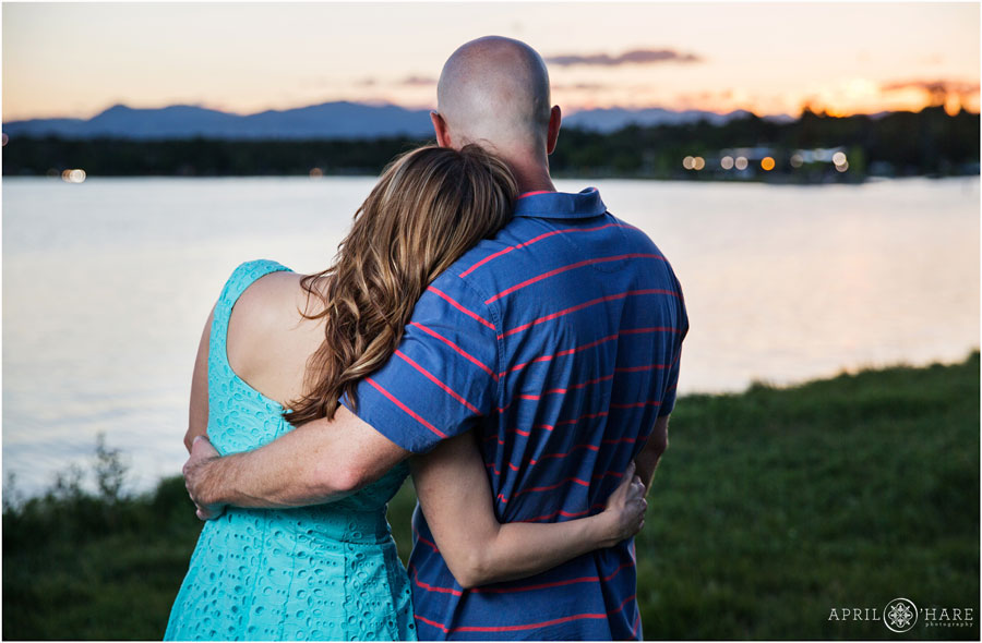 Sloan's Lake Engagement Photos with couple looking out at the lake and sunset views with the mountains