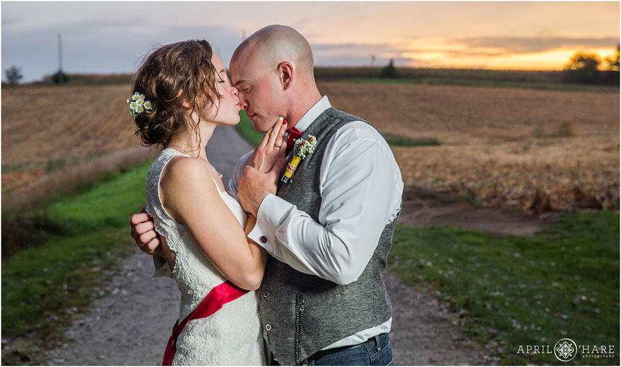 Romantic kiss with pretty sunset backdrop at Nebraska Farm Wedding