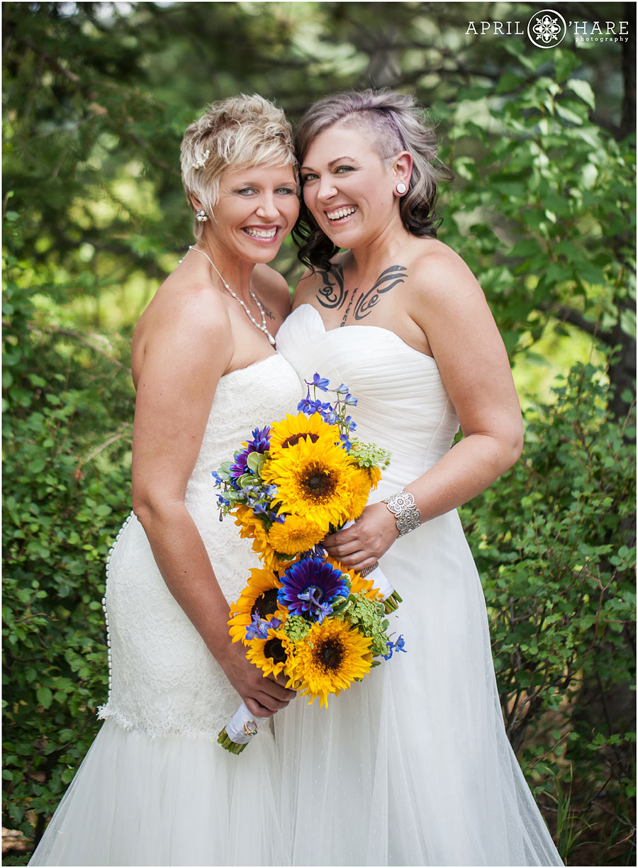Two beautiful brides with yellow sunflower bouquets at Backyard Lesbian Wedding