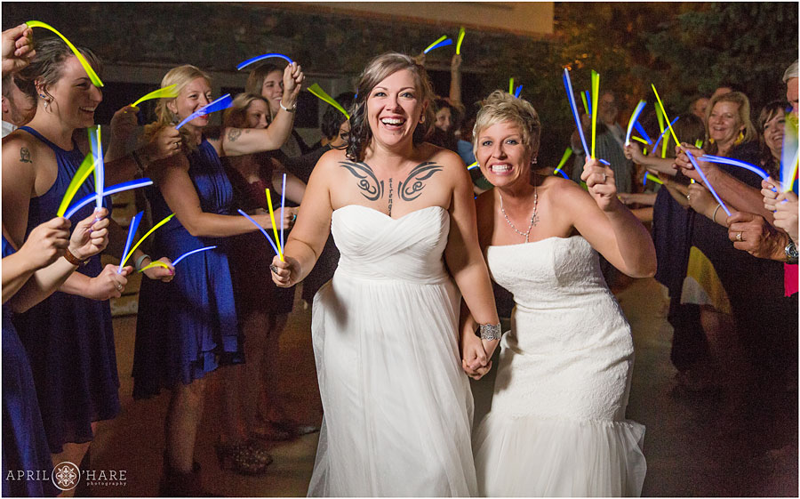 Blue and yellow wedding glowstick grand exit at Backyard Lesbian Wedding