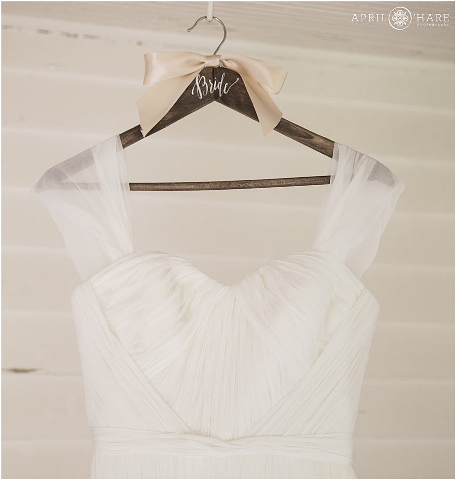 Marchesa Wedding Gown from Little White Dress Shop Hangs at a Colorado Rustic Wedding Venue Chatfield Farms