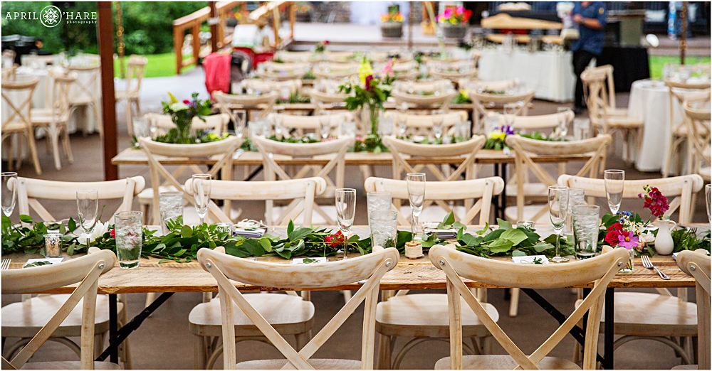 Wood chairs and tables decorated with florals by Pink Champagne Events in Idaho Springs CO