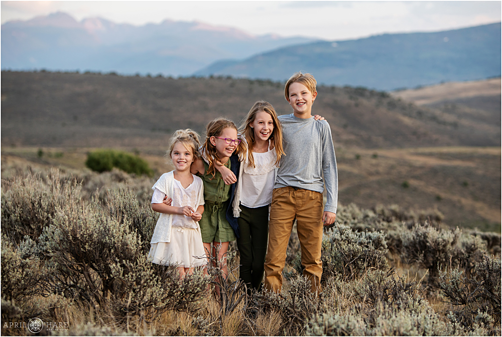 Happy siblings together during family pictures in Colorado