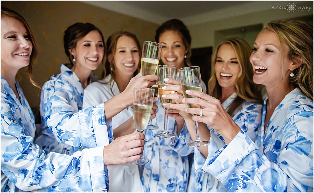 Bride and Bridesmaids Cheers with Champagne at a Colorado mountain wedding