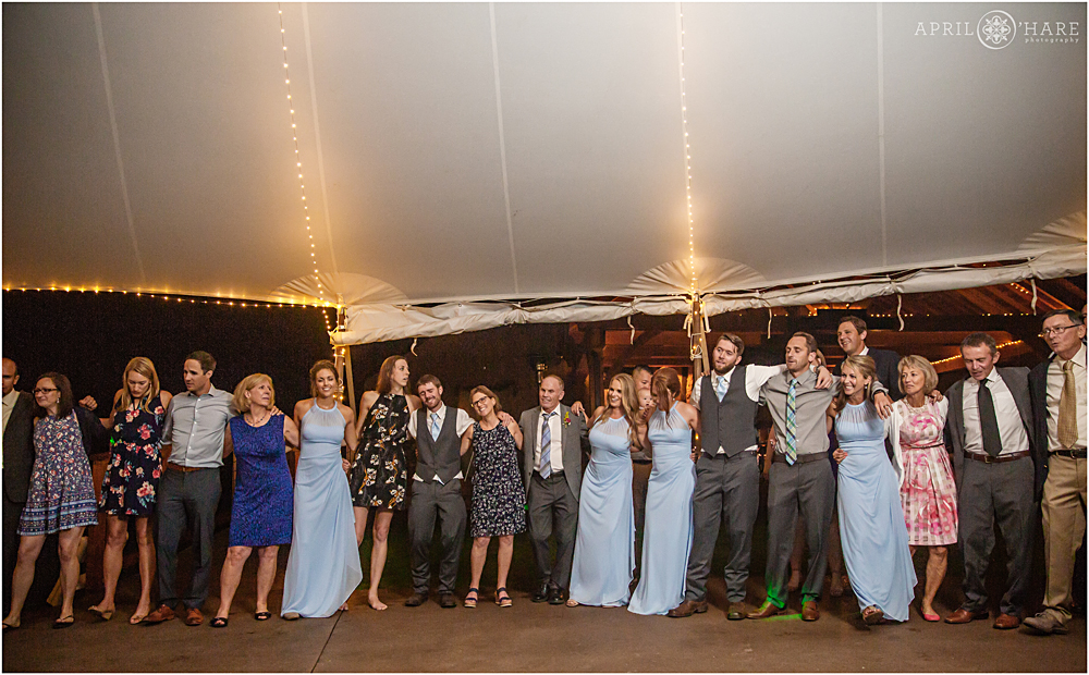 Party-goers sing along in a huge circle at a wedding