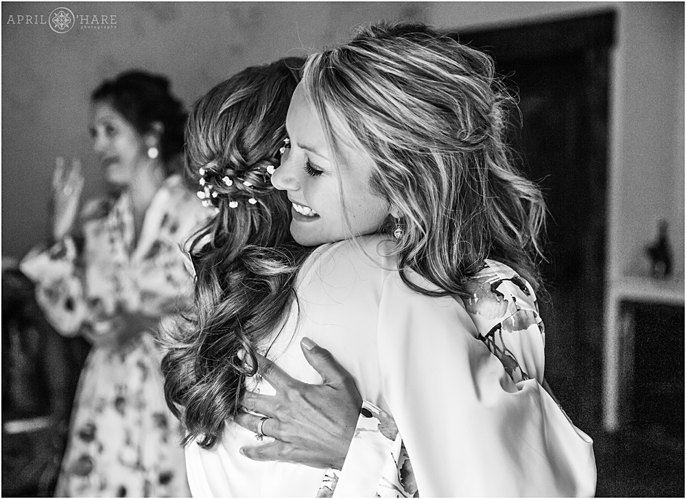 Bridesmaid hugs her friend on her wedding day at Blackstone Rivers Ranch