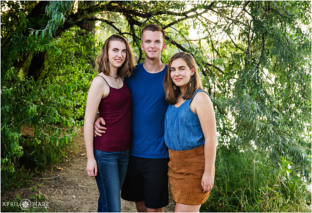 Teenage siblings pose for a portrait at Coot Lake near Boulder Reservoir