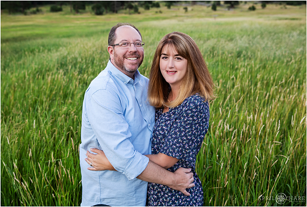 Couples portrait in a field of tall grass in Evergreen Colorado at Alderfer/Three Sisters park