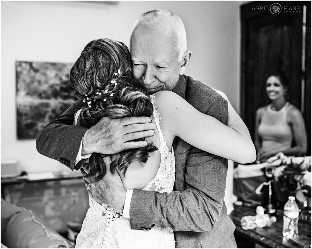 Dad hugs his daughter after seeing her for first time on wedding day