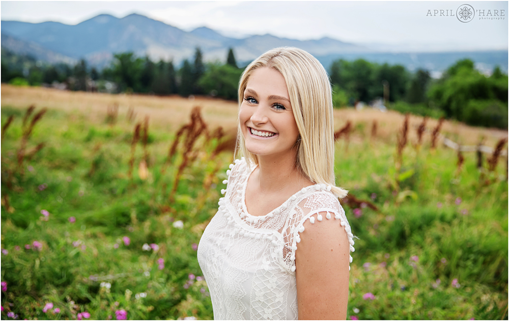 Young blonde daughter headshot portrait with mountain backdrop