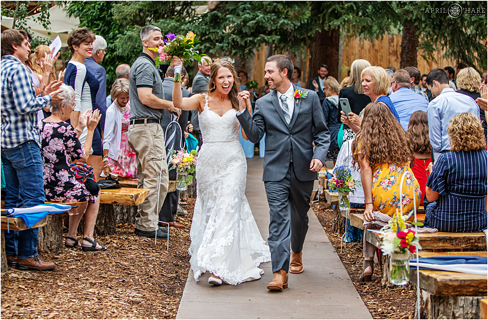 Couple celebrating and walking down the aisle at their wedding at Blackstone Rivers Ranch in CO