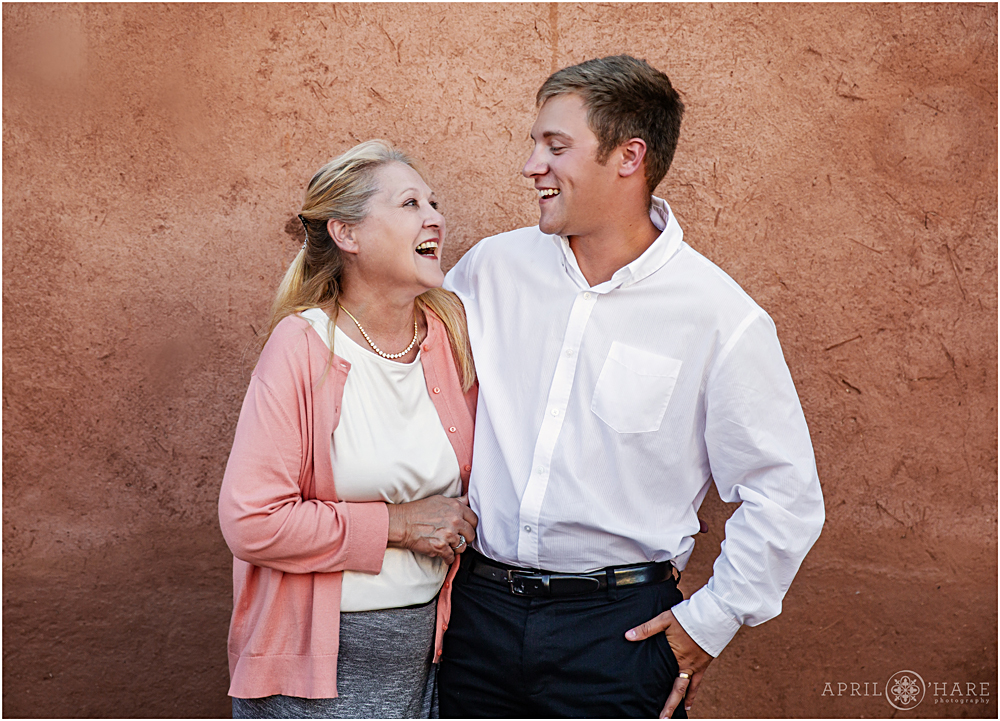 Groom and his mom laugh during family formals at The Fort Restaurant in CO
