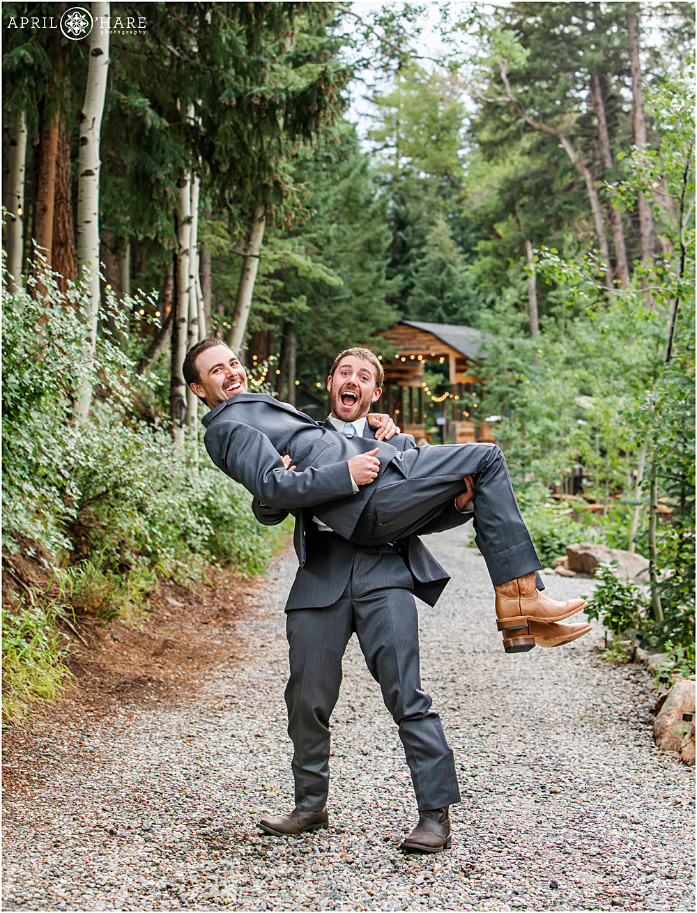 Groom and his brother who is the best man pose for a silly photo together