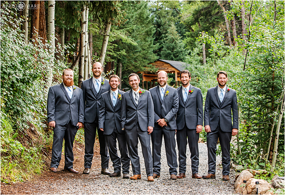 Dapper group of men pose for a photo during wedding at Blackstone Rivers Ranch