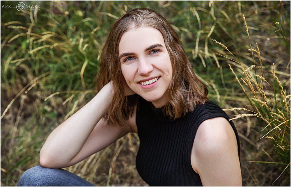 Close up horizontal senior portrait headshot in the tall grasses along Clear Creek Canyon